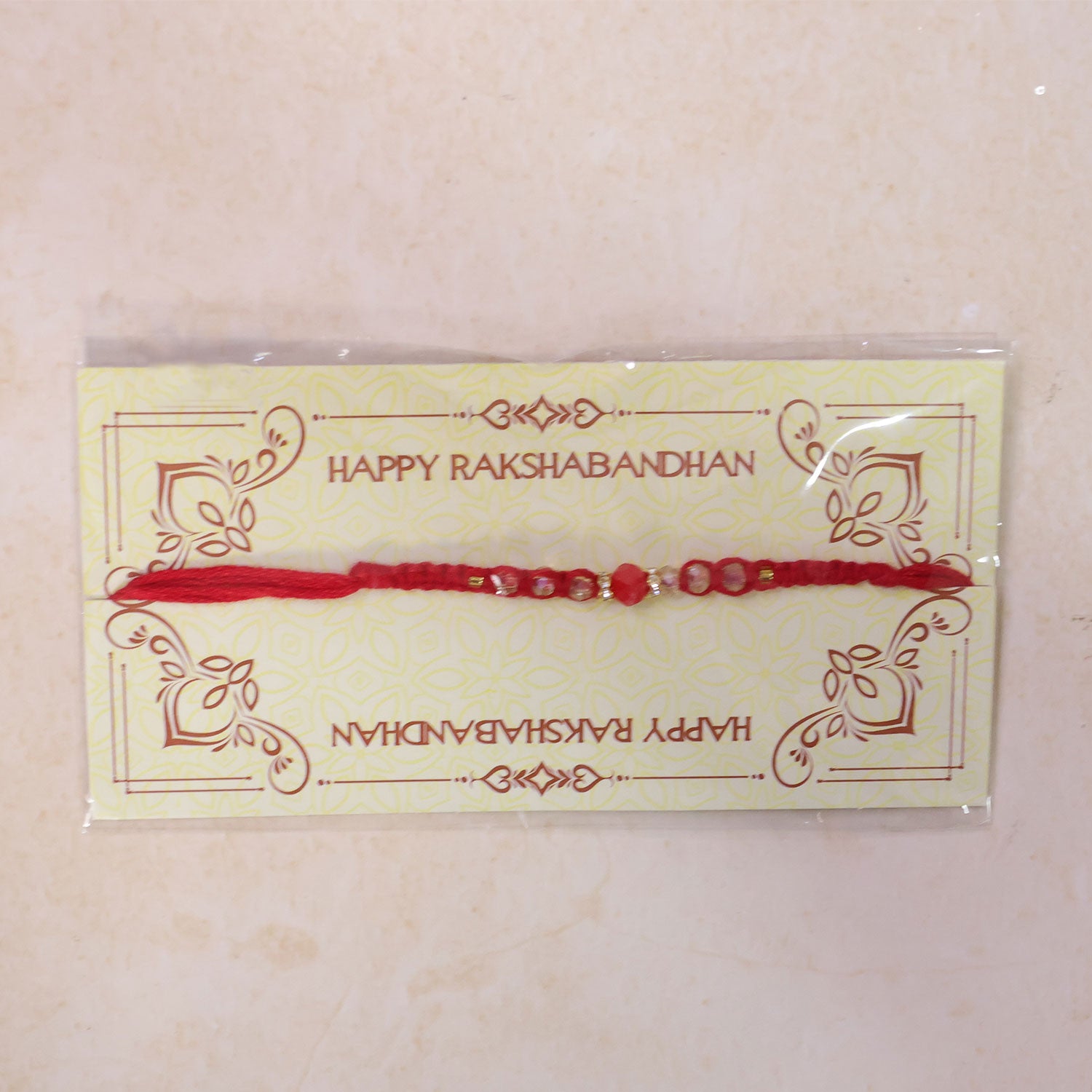 Red Braided Rakhi with a Row of Sparkling Crystal Bead Accents