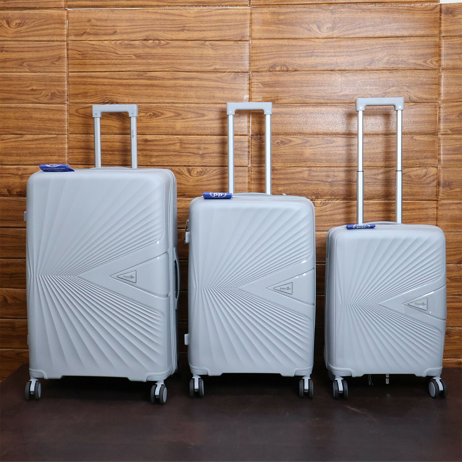 Traveller pulling grey hard shell travel luggage equipped with spinner wheels