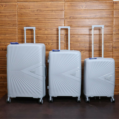 Traveller pulling grey hard shell travel luggage equipped with spinner wheels