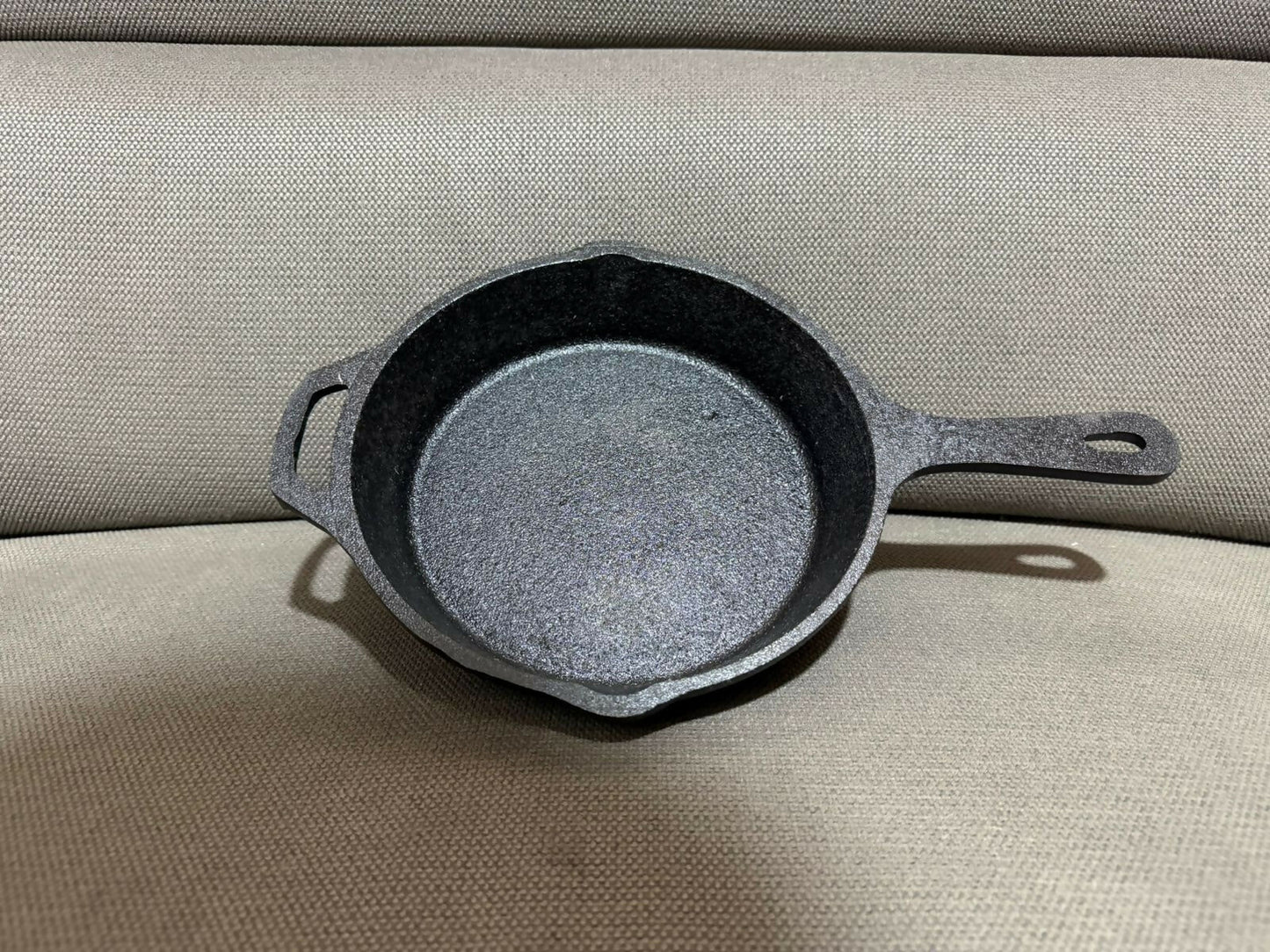 Vikas cast iron frypan outdoors over open campfire