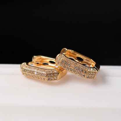 Side view of gold finish CZ studded hoop earrings for women