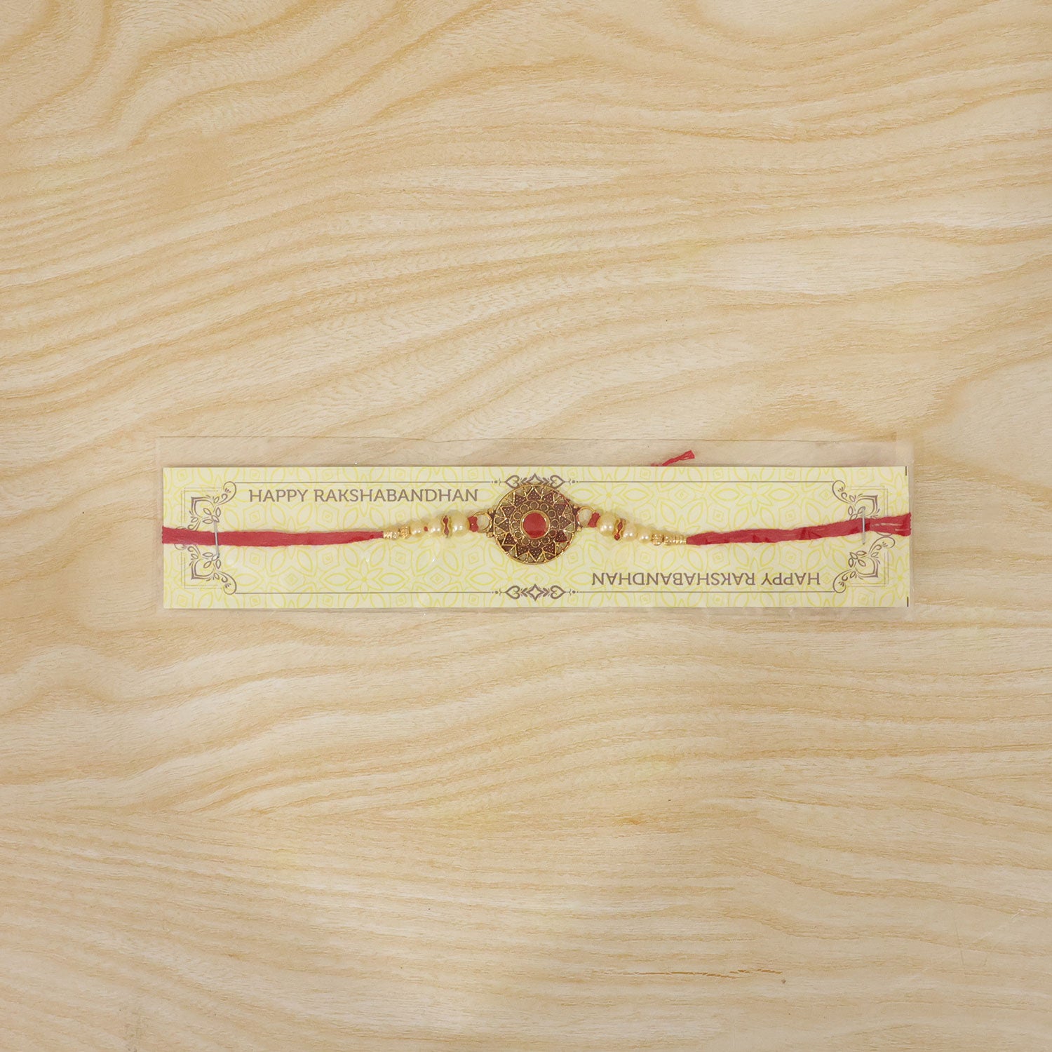 Premium Traditional Rakhi – Red Stone & Pearl Beads Elegant Design