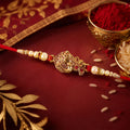 Golden Peacock Rakhi – Pearl Beads & Red Thread for Brother on Raksha Bandhan