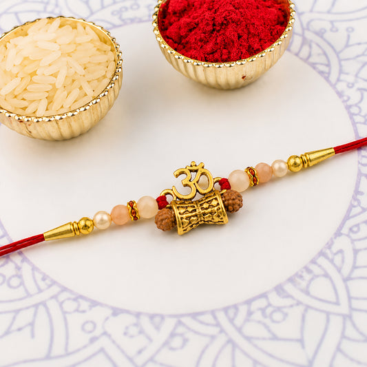 Golden Charm Rakhi – Pearl Beads & Vibrant Red Thread for Brother