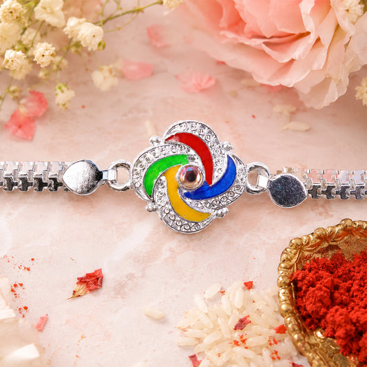 Silver Rakhi with feather detailing and metal chain on a clean background.
