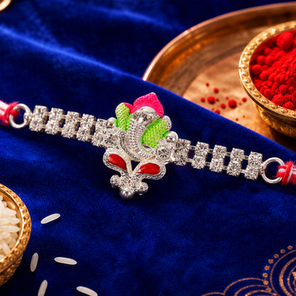 Silver-Toned Lord Ganesha Rakhi with Pink-Green Enamel, Double Crystal Chain & Red-White Thread