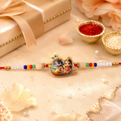 Close up of Krishna Radha Rakhi with intricate motif and decorative beads.