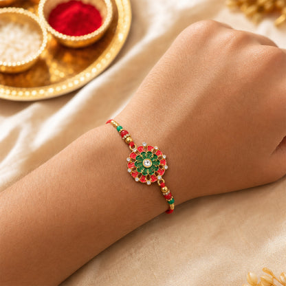 Angled view of the handcrafted Rakhi showing intricate red and green beadwork.