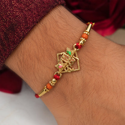 Close-up of Radha Krishna Rakhi, highlighting the golden charm and intricate crystal beadwork.