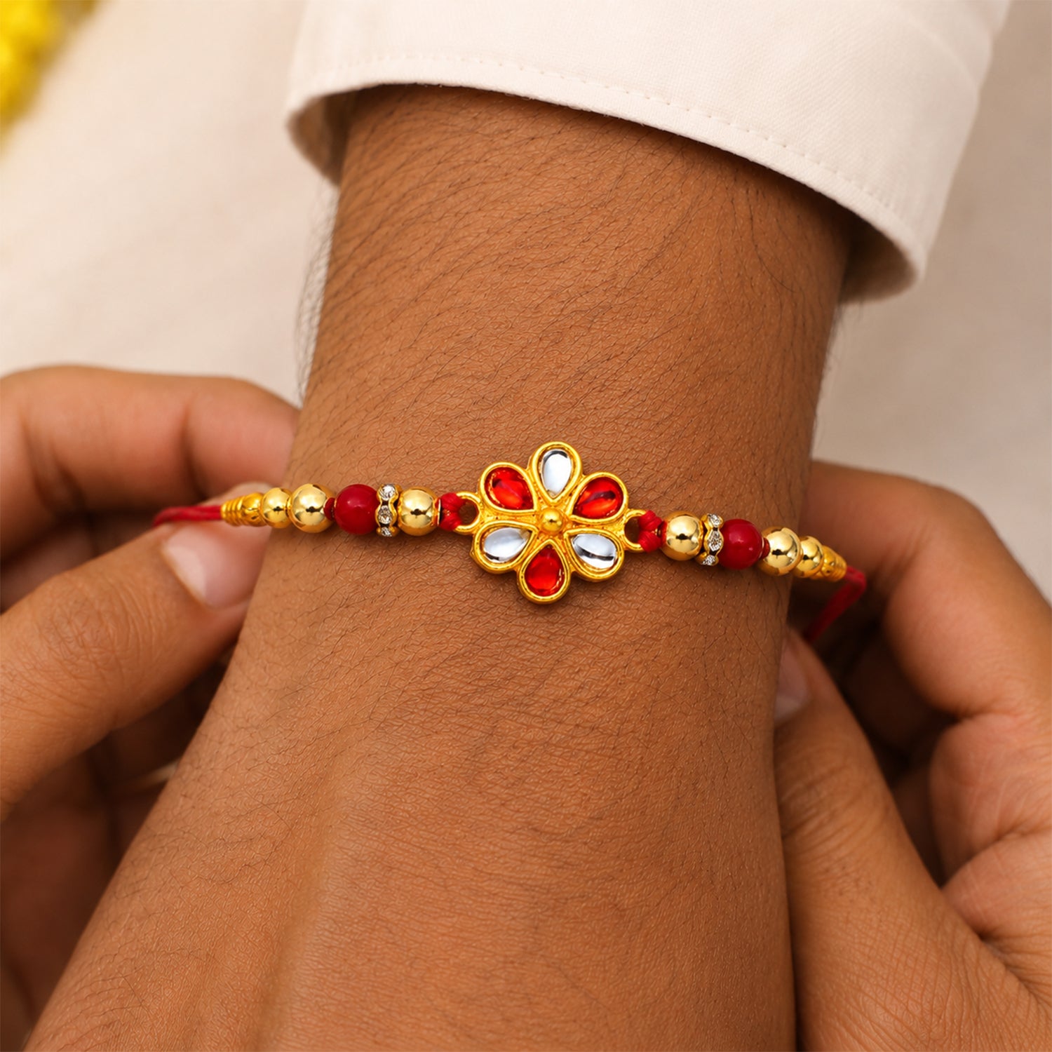 Red White Beaded Rakhi with Kundan Floral Centerpiece – Elegant Design