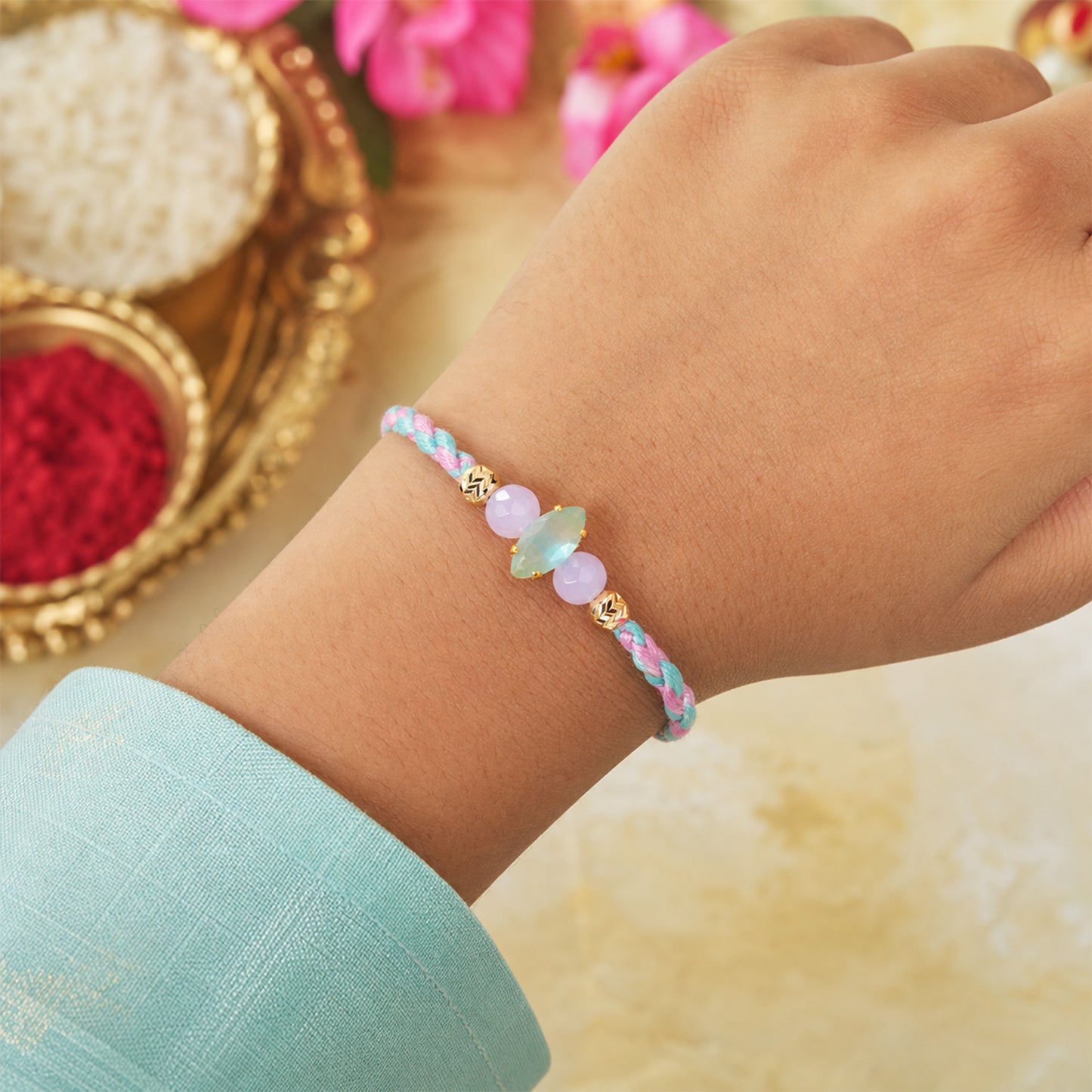 Flat lay of a Designer Rakhi featuring festive beads and traditional thread.