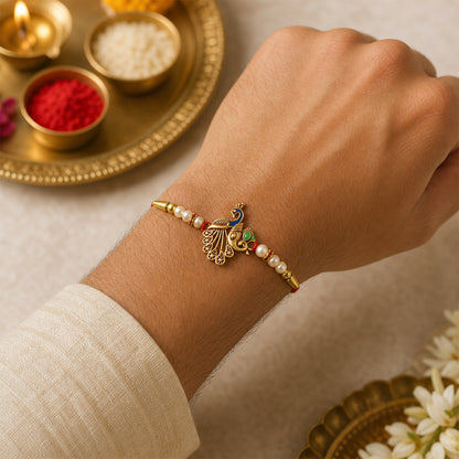 Peacock Design Rakhi – Elegant Pearl Beads & Golden Detailing