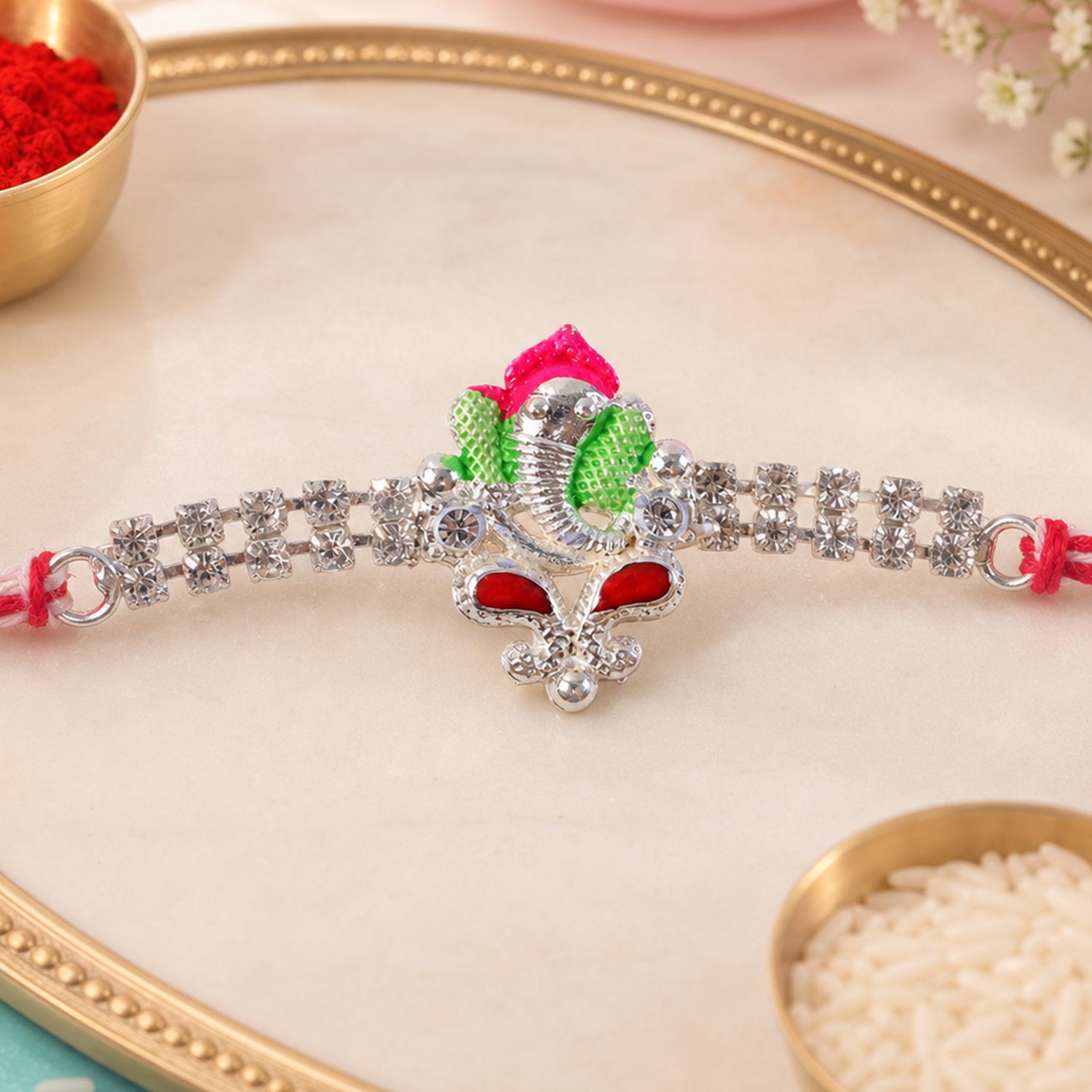 Silver-Toned Lord Ganesha Rakhi with Pink-Green Enamel, Double Crystal Chain & Red-White Thread