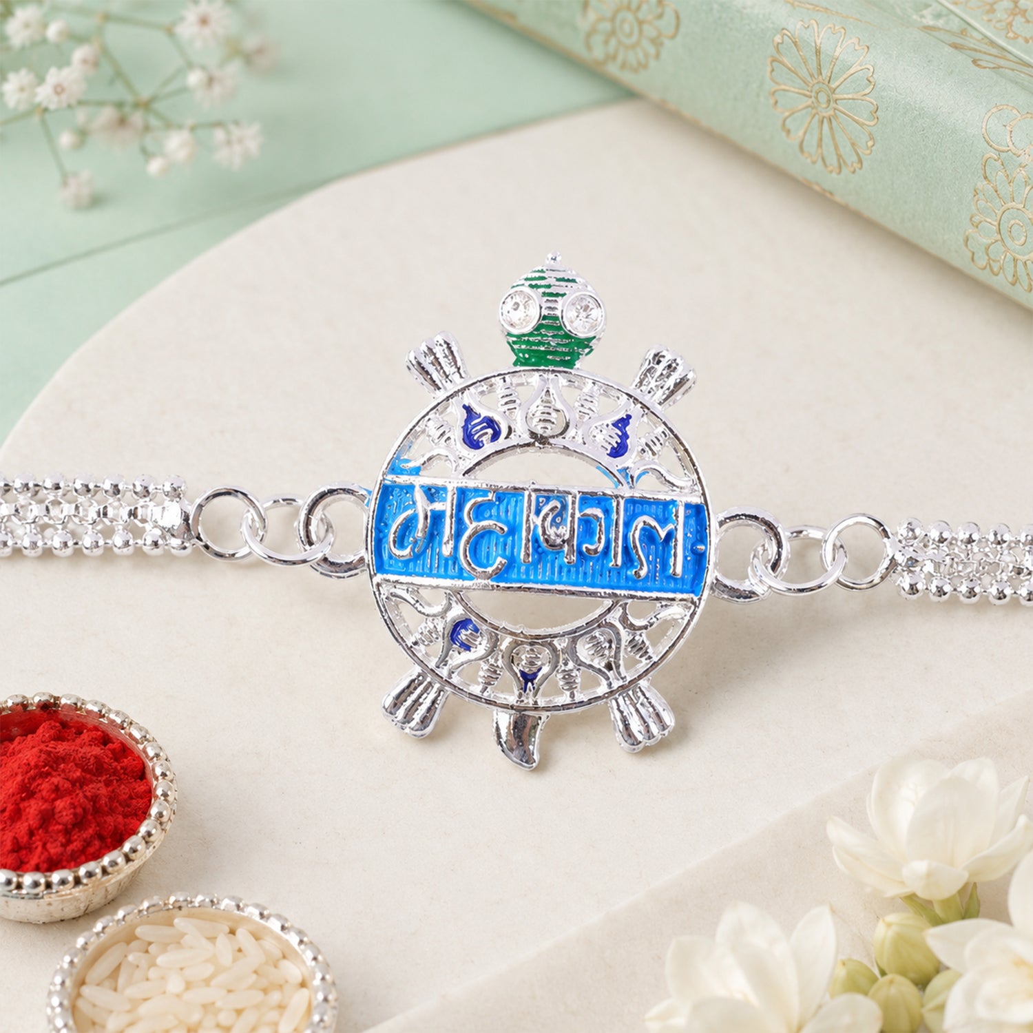 Mahakal text charm Rakhi displayed on a festive occasion background for Raksha Bandhan.