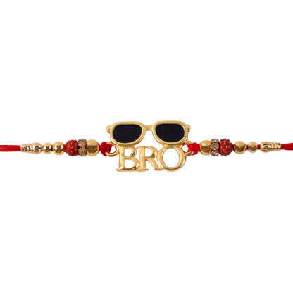 A red and gold Rakhi with a "BRO" charm and sunglasses, centered on a plain white background.