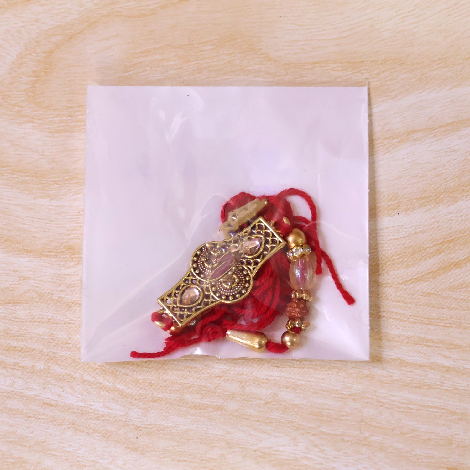 Rose Pink Kundan Stone Pendant Rakhi with Rudraksha and Coral Beads