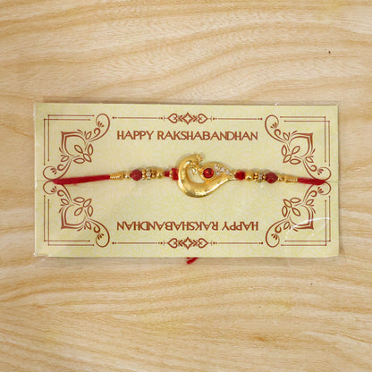 Peacock Feather Rakhi – Golden & Kundan Detailed Red Thread