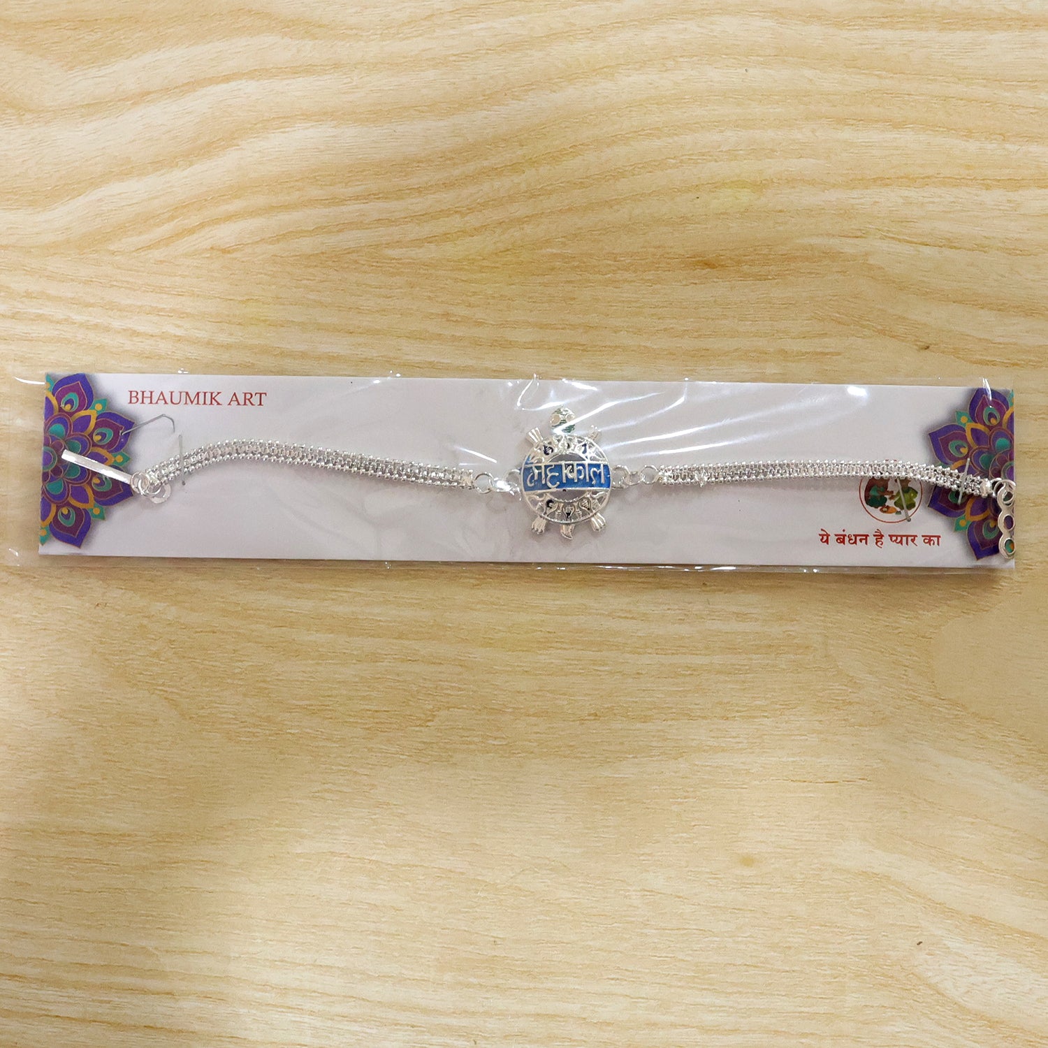 Another angle of the Mahakal text charm chain Rakhi for festive gifting.