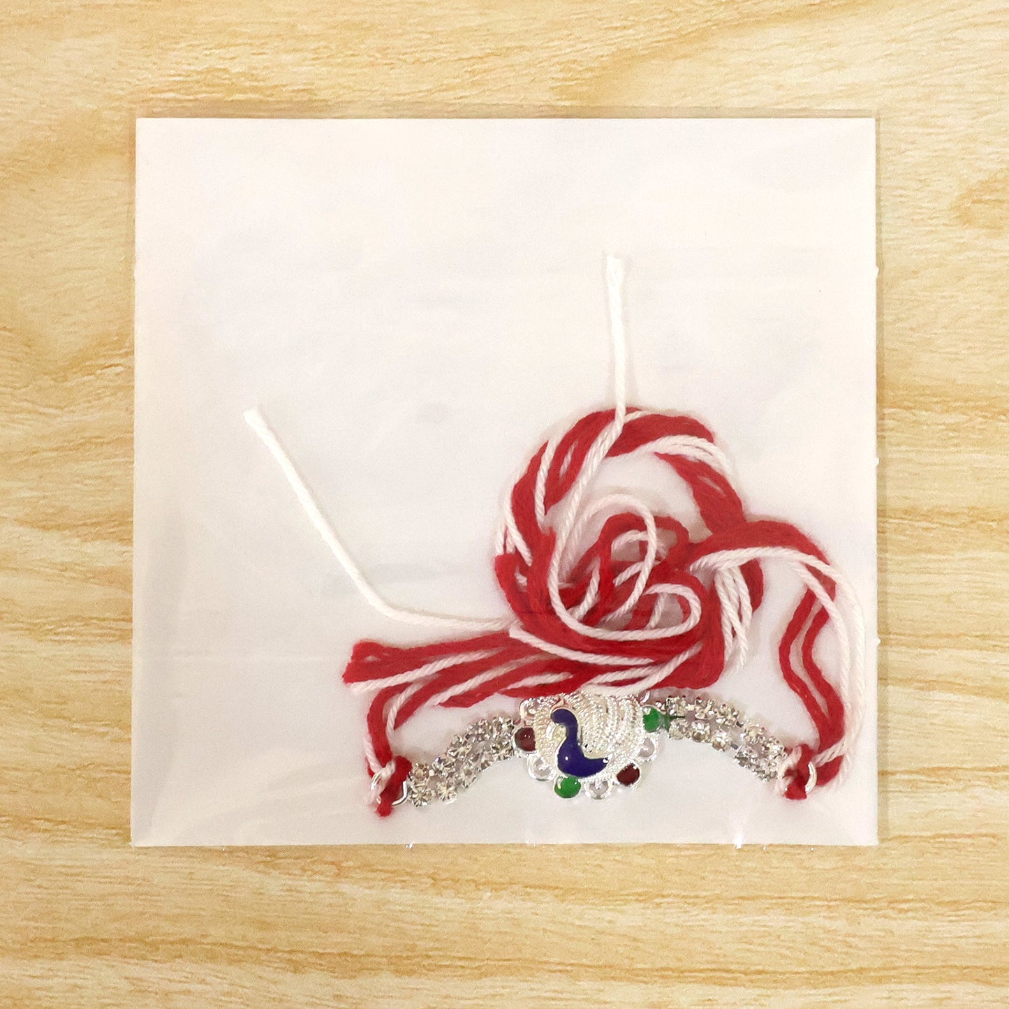 Classic Rakhi showcasing Paisley Swirl Charm, crystal sparkle and gift style for Gift