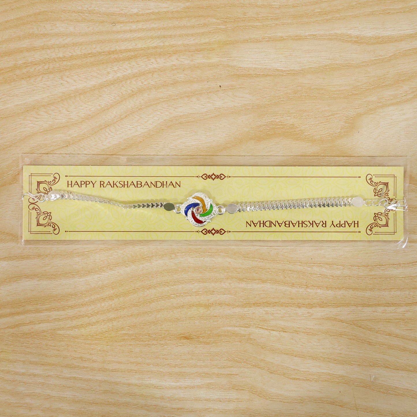 Festive Silver Rakhi with traditional decorations for Raksha Bandhan celebrations.