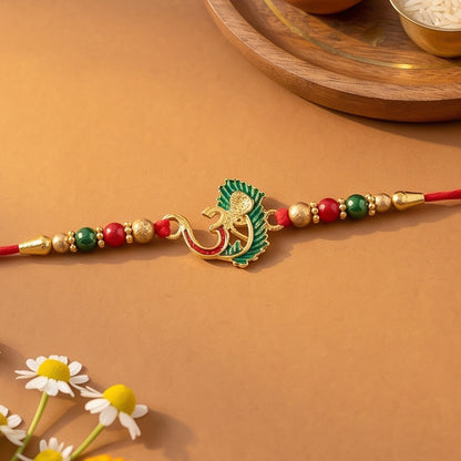 Om Rakhi with peacock feather alongside other festive items for Raksha Bandhan.
