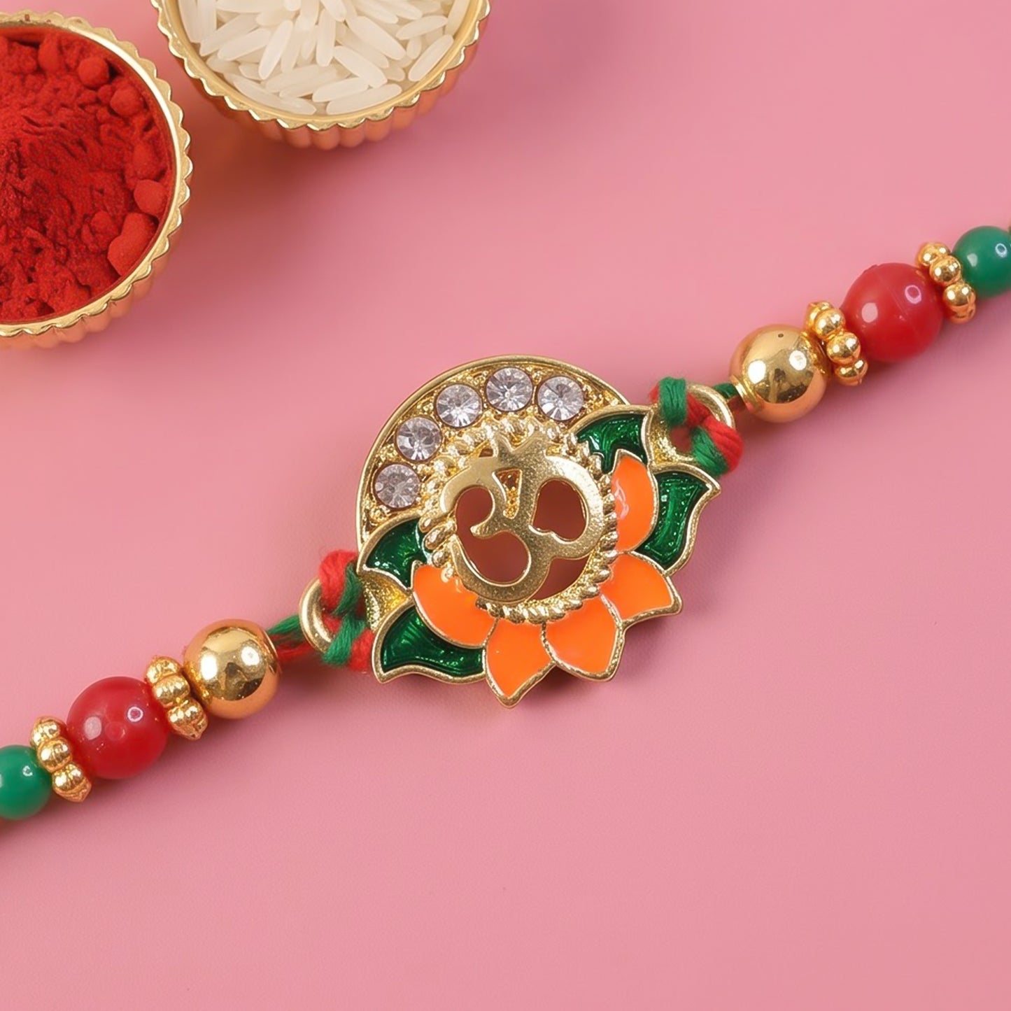 Lotus Om Pendant Rakhi with Orange Petals and Kundan Stones