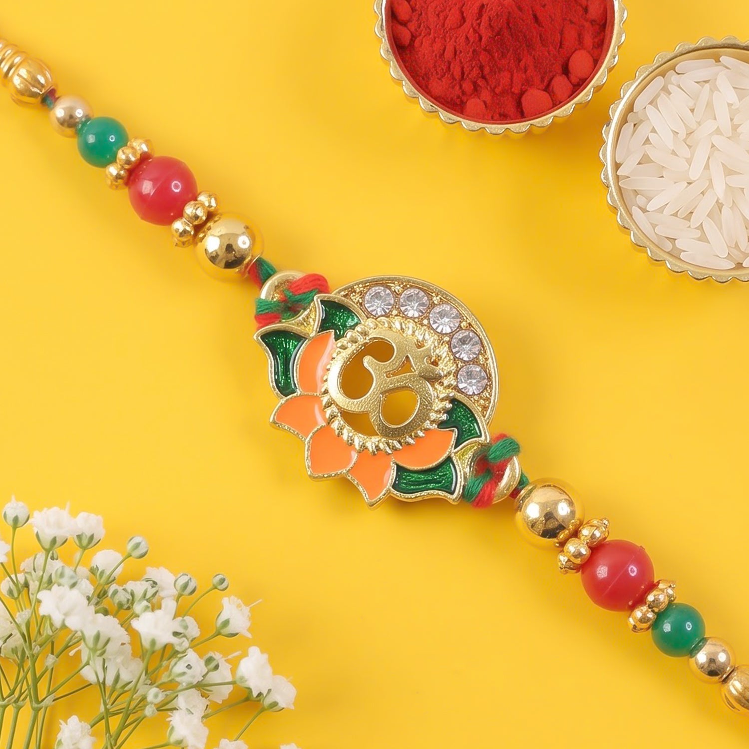 Lotus Om Pendant Rakhi with Orange Petals and Kundan Stones