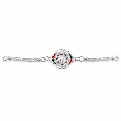 Top view of silver floral rakhi showcasing its detailed pattern.