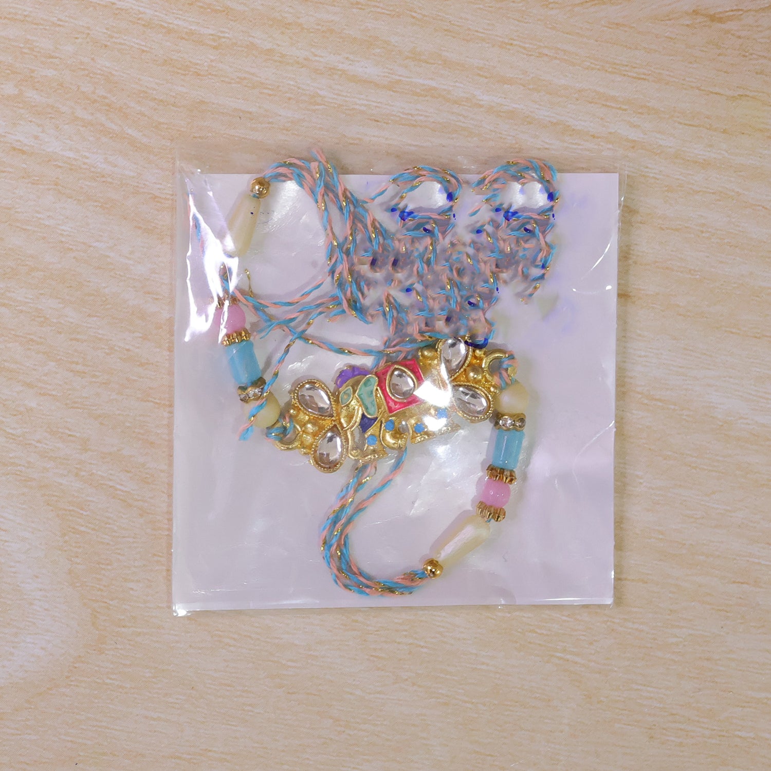 Kundan Elephant Pendant Rakhi with Pastel Beads