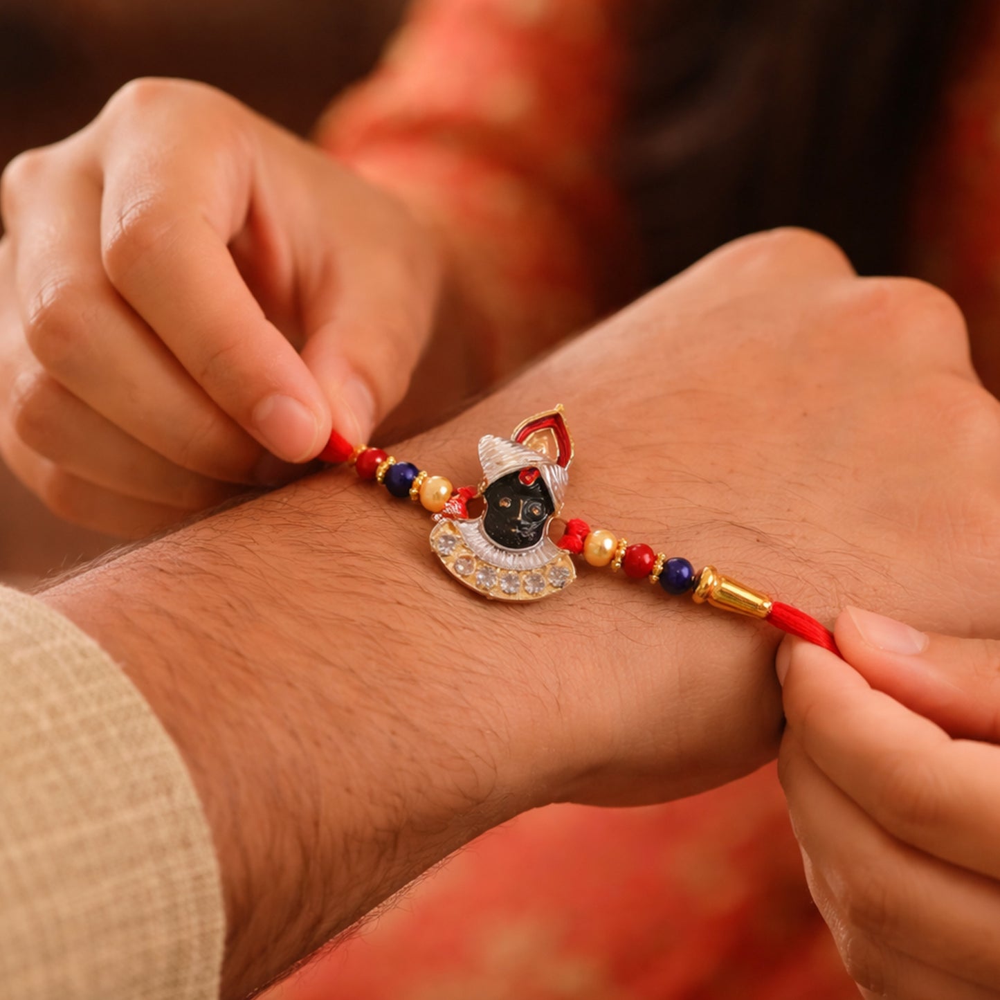 Decorative festive Krishna Rakhi on soft thread