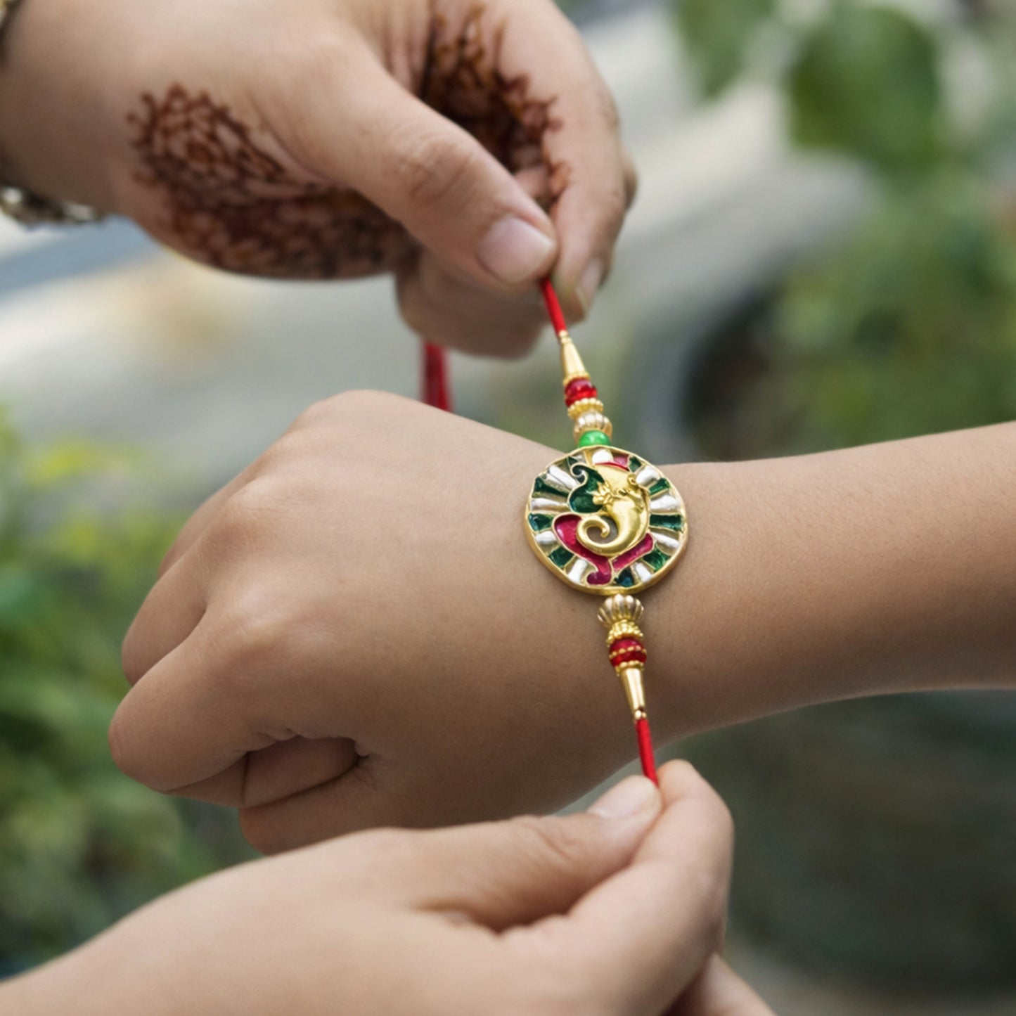 Soft thread and bead decoration of Ganesha themed Rakhi