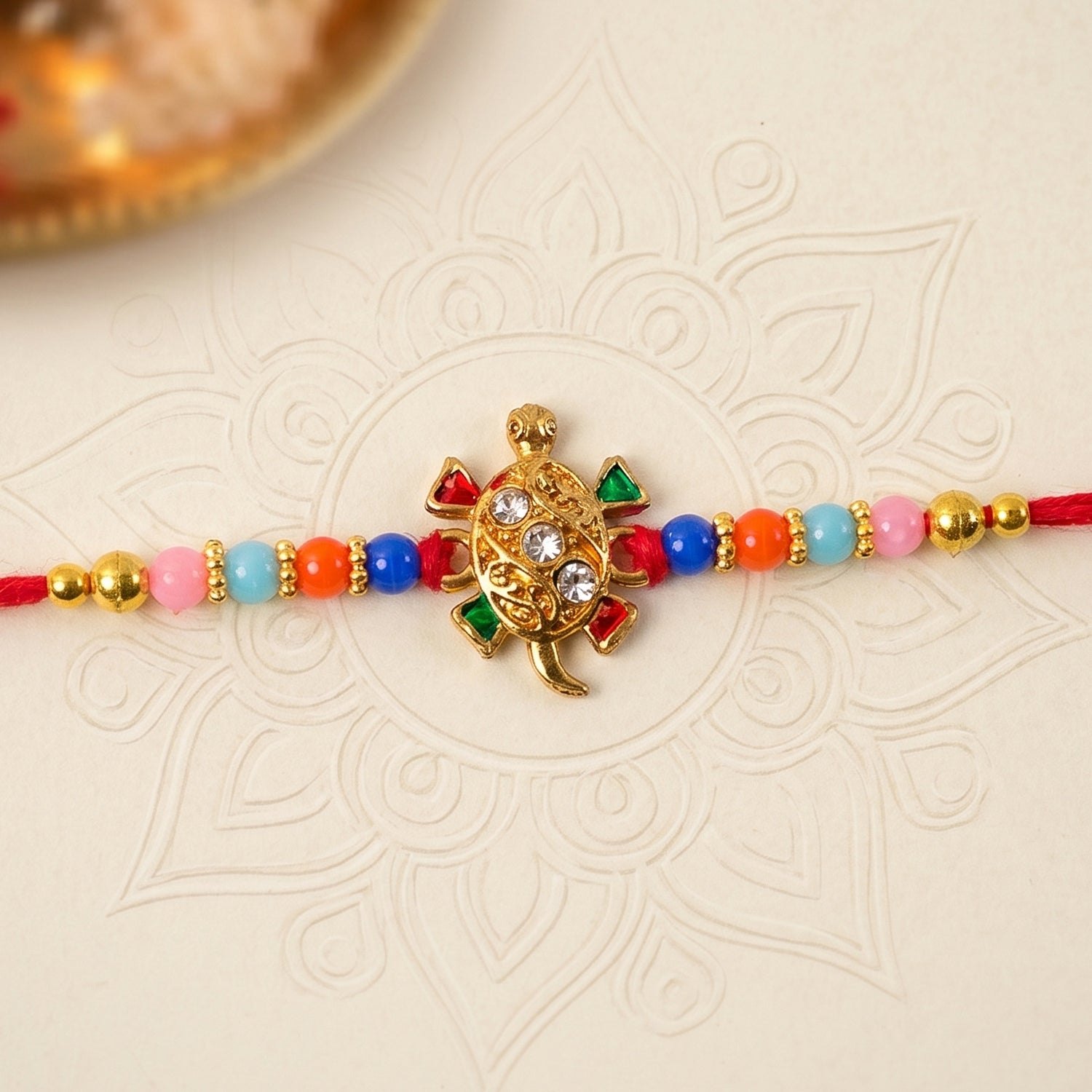 Side view of Cute Turtle Design Rakhi showing bead details