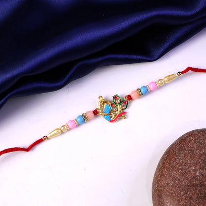Festive rakhi featuring peacock design and colorful beads
