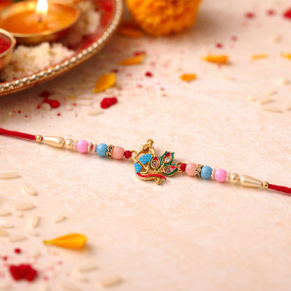 Close-up of elegant peacock motif rakhi