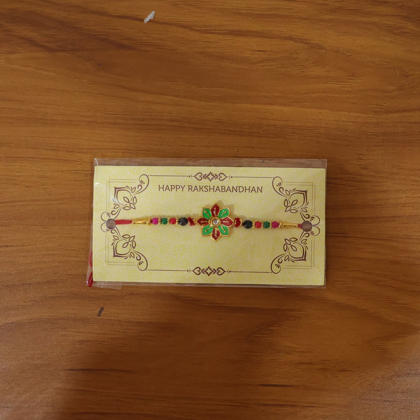 Live image of floral design rakhi on wrist