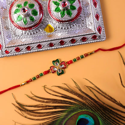 Side view of designer rakhi showing bead details and thread
