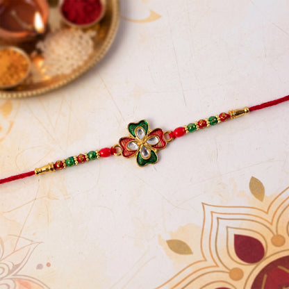 Traditional rakhi featuring floral design and decorative stones