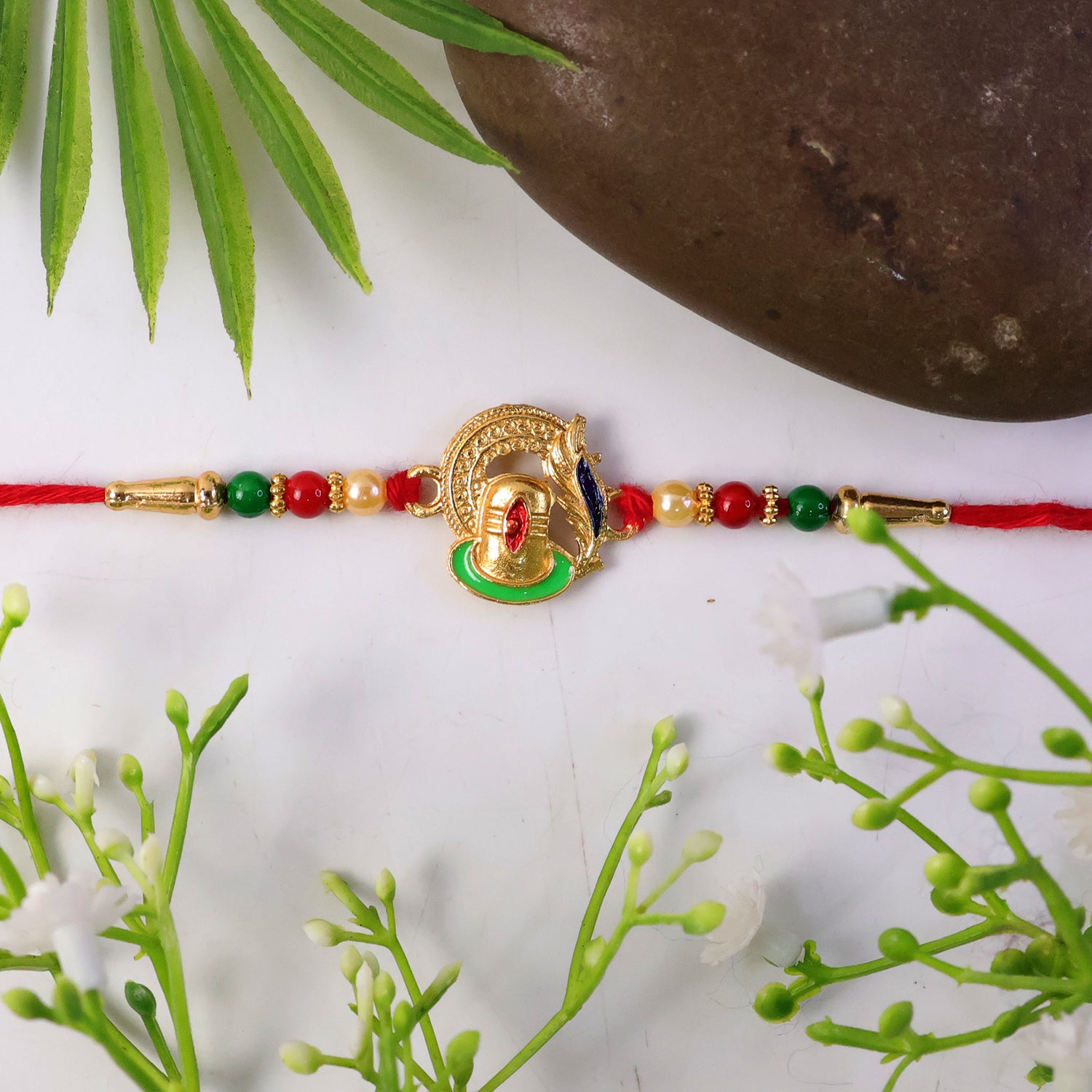 Detailed look at colorful beads on Ganesha rakhi
