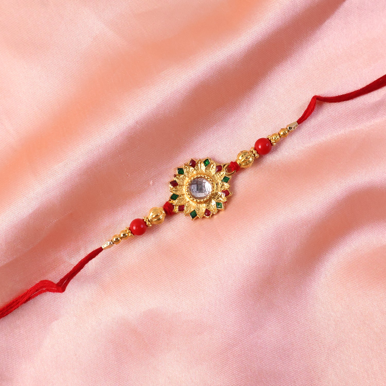 Hand holding Veera Ki Rakhi showing intricate craftsmanship