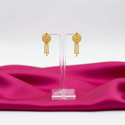 Side angle of gold-plated jhumka earrings showing detailed filigree work and golden beads