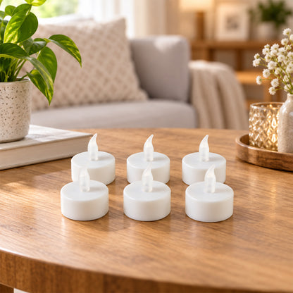 Six white LED flameless candles with clear plastic flames arranged on a wooden table in a living room setting.