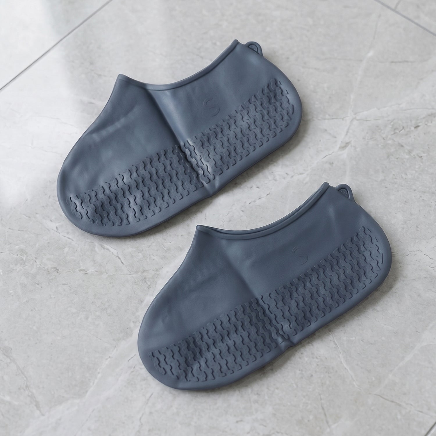 Shoe covers worn outdoors on wet pavement