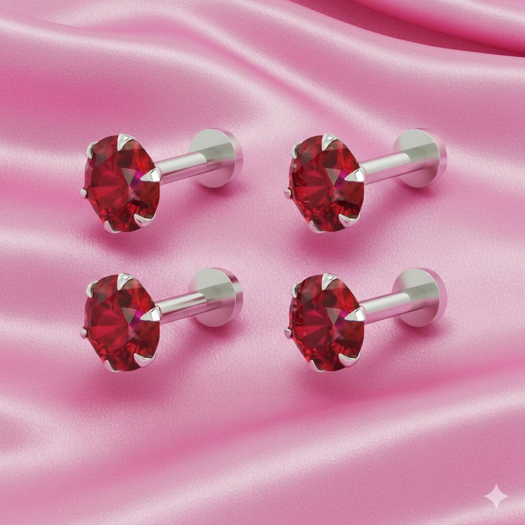 Close-up of silver plated labret stud with ruby red crystal