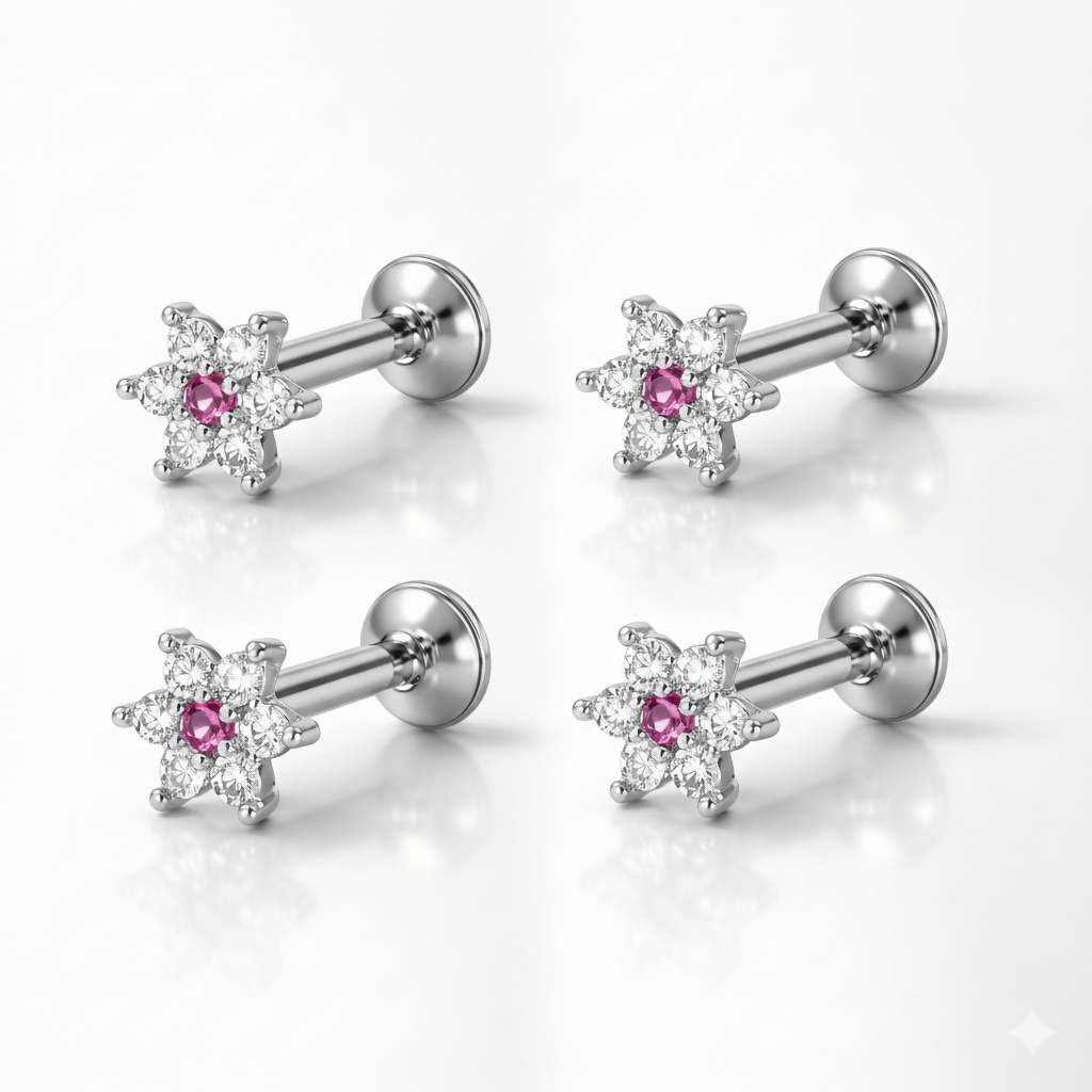 Two pairs of silver plated flower stud earrings with ruby and crystal detailing