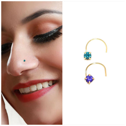 Close-up of gold plated nosepin featuring teal square crystal
