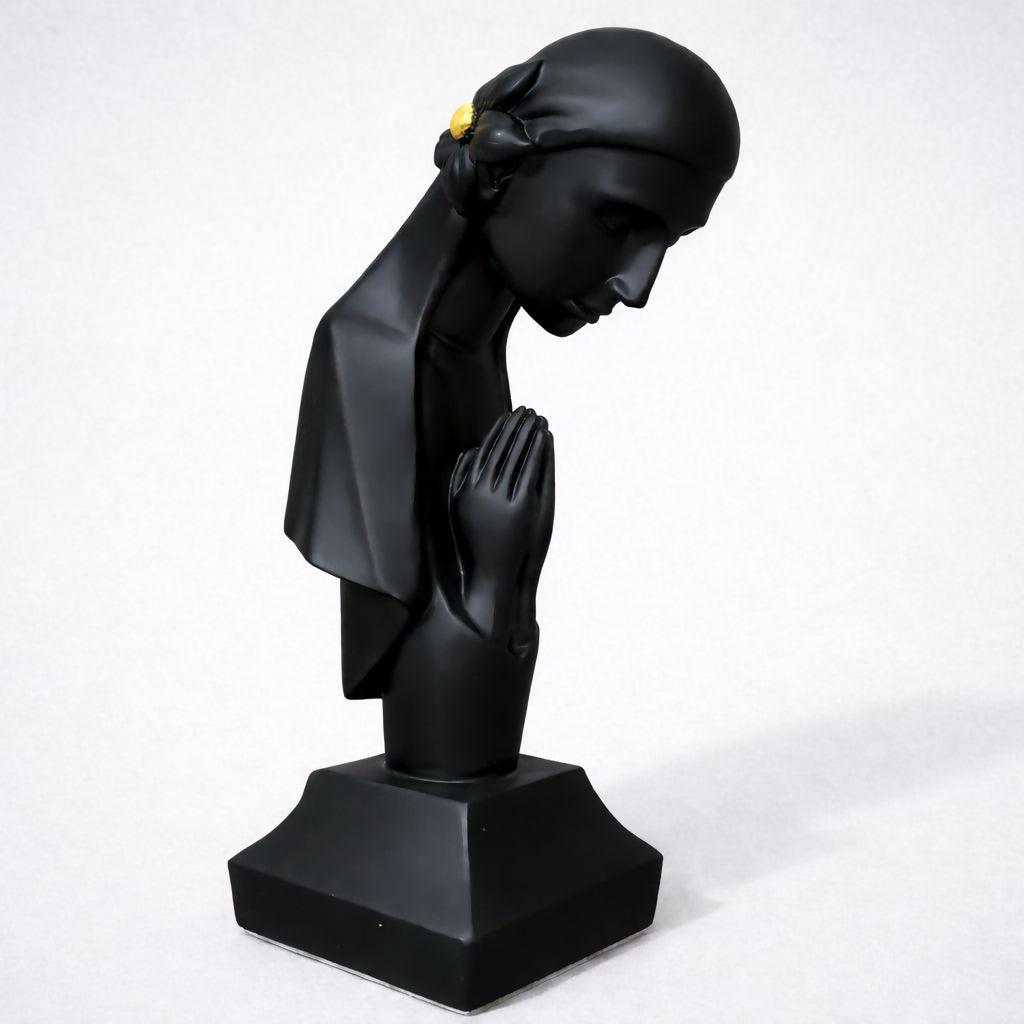 Close-up of smooth matte finish on praying lady sculpture