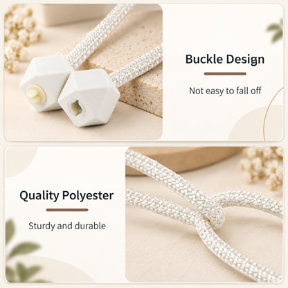 Close-up of the white geometric plastic buckle design and the braided polyester rope of the tieback.
