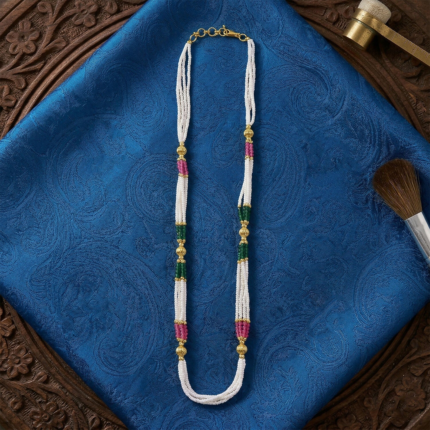 Side view of multi-layered beaded mala with gold accents