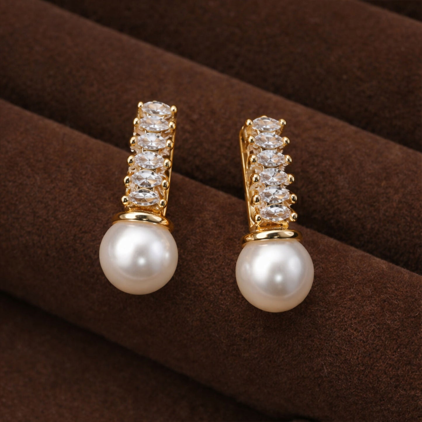 Gold finish pearl drop earrings featuring sparkling stone vertical bar design