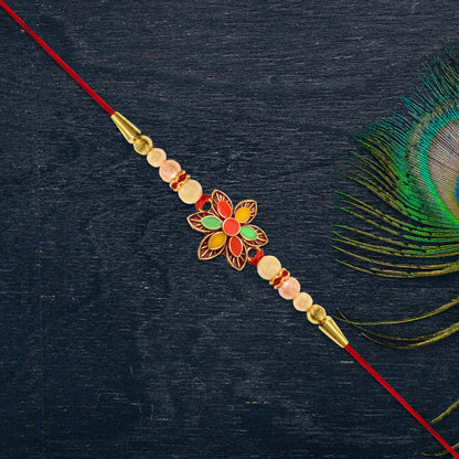 Handcrafted floral bead rakhi featuring blue thread and elegant central stone details.
